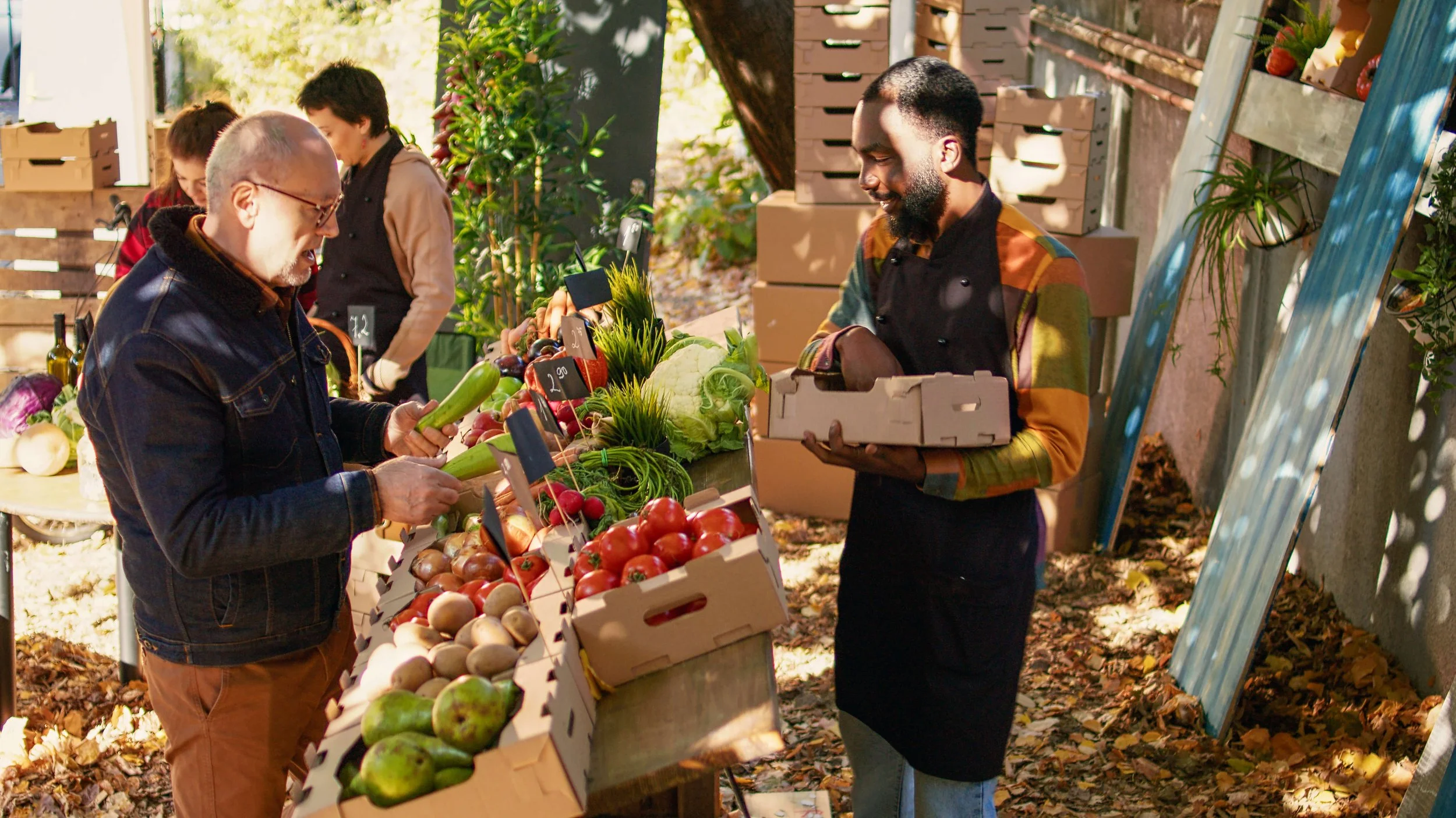 African American farmer selling organic vegetables at an outdoor market